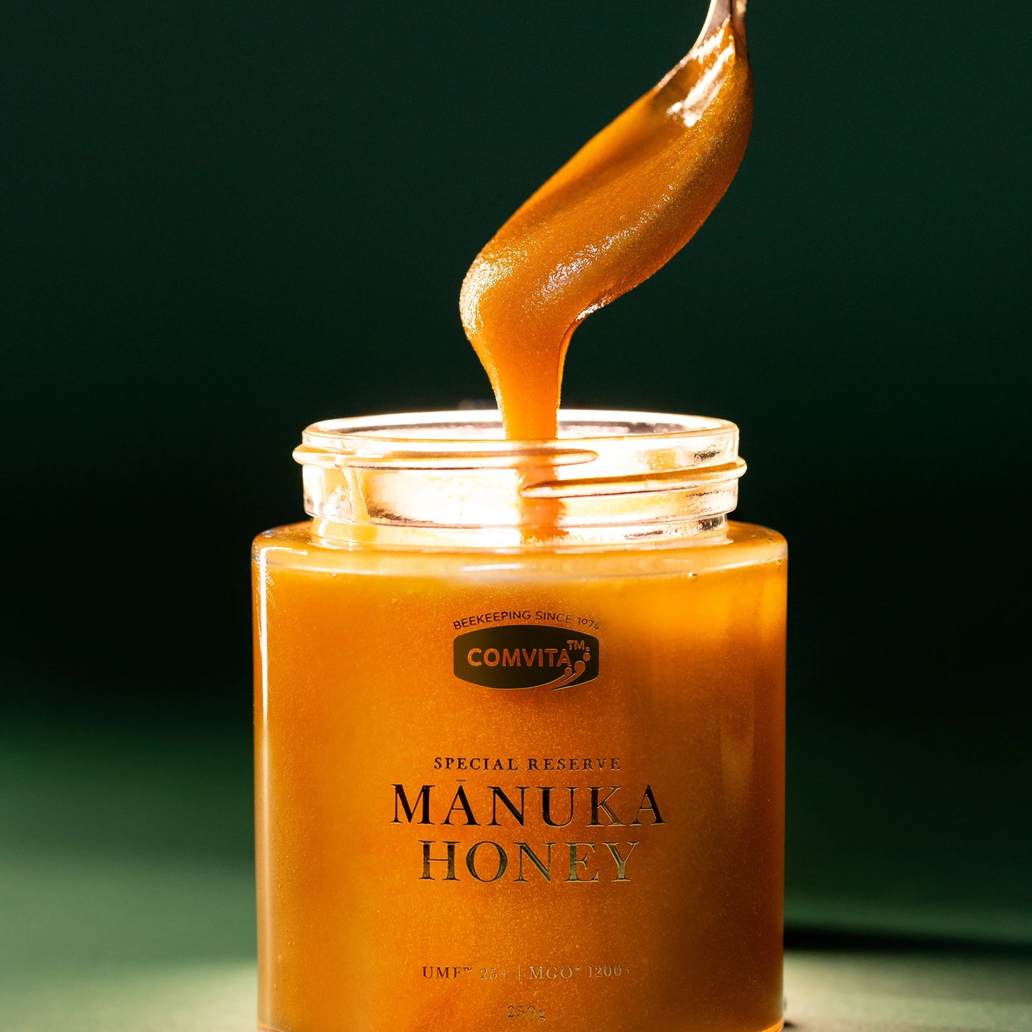 UMF25+ Manuka Honey open Jar with spoon taking honey