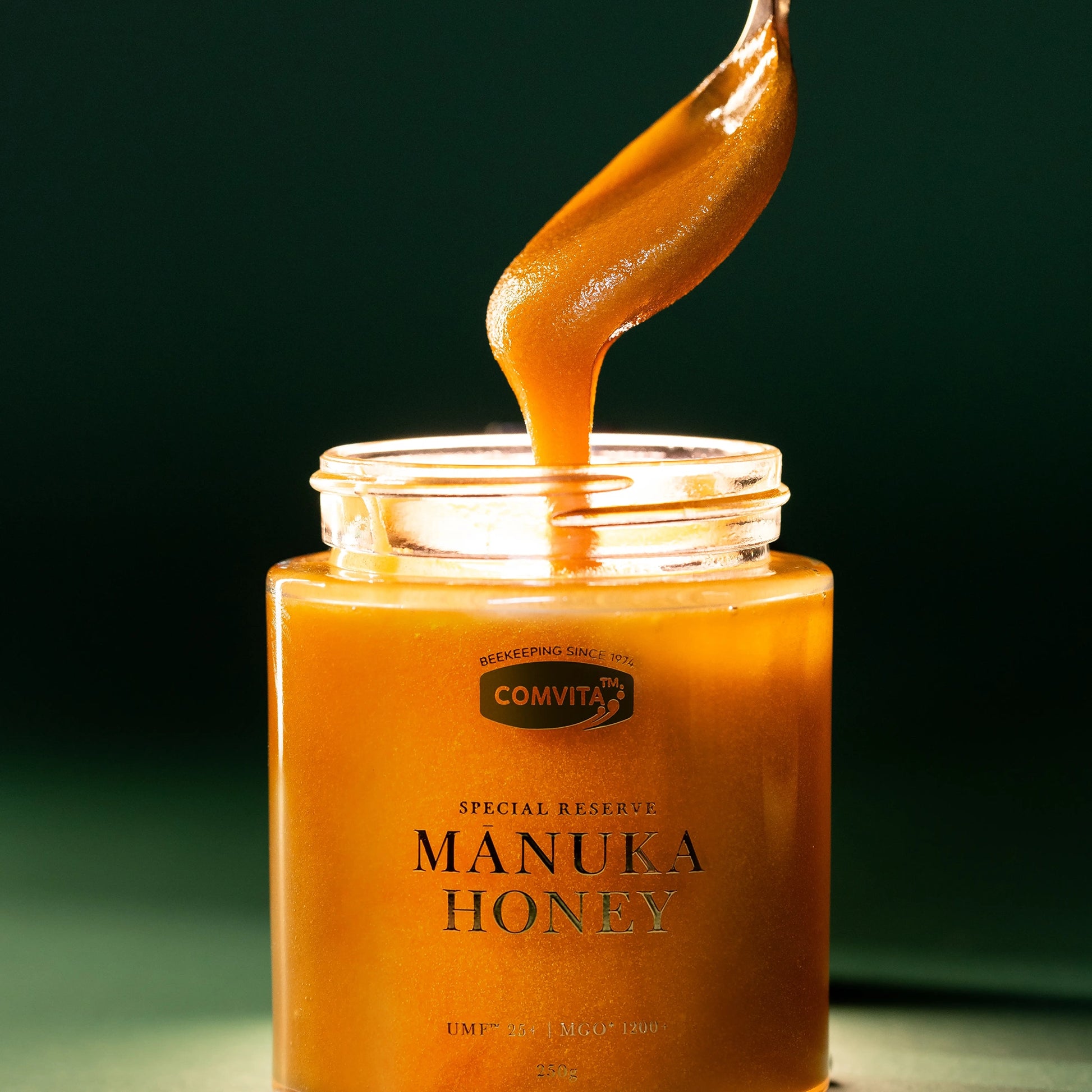 UMF25+ Manuka Honey open Jar with spoon taking honey