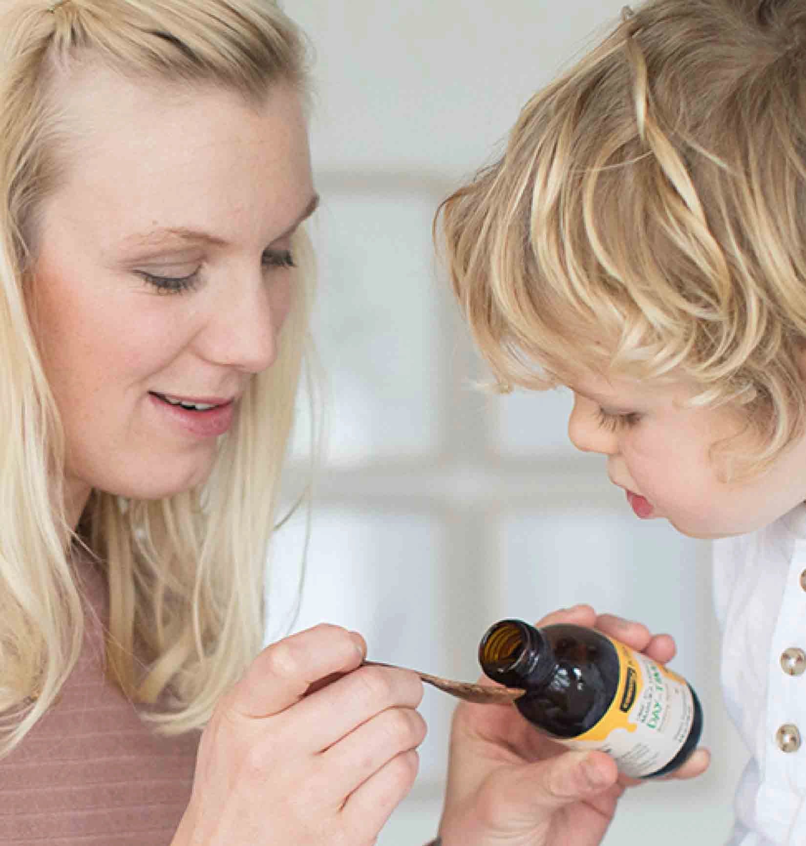Mother giving child some elixir
