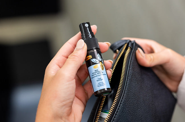 Propolis oral spray being put in bag for travel