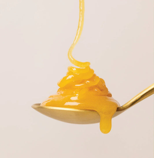 honey dripping into a spoon